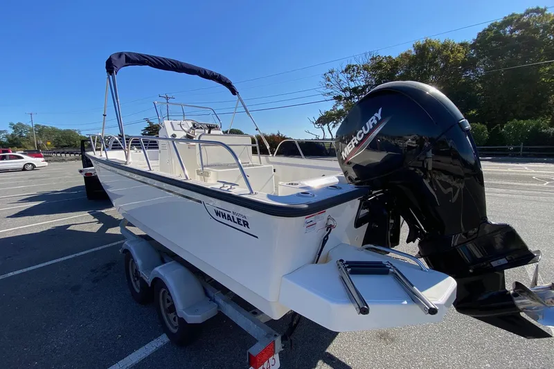 Slide: The Image of 2023 Boston Whaler 190 Montauk boat with Mercury engine on trailer in parking lot. - 4