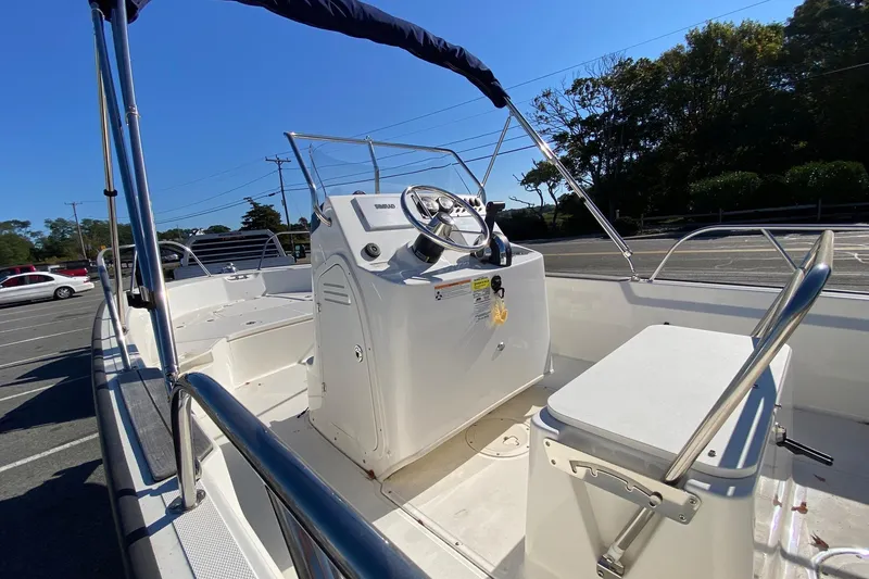 Slide: The Image of 2023 Boston Whaler 190 Montauk boat interior with steering console and seating. - 5