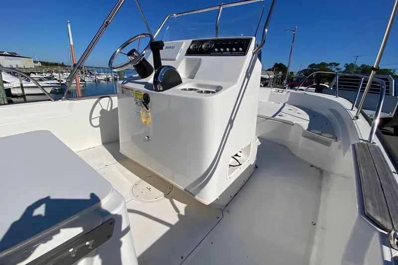 Slide: The Image of 2023 Boston Whaler 190 Montauk boat interior with steering console and seating. - 9