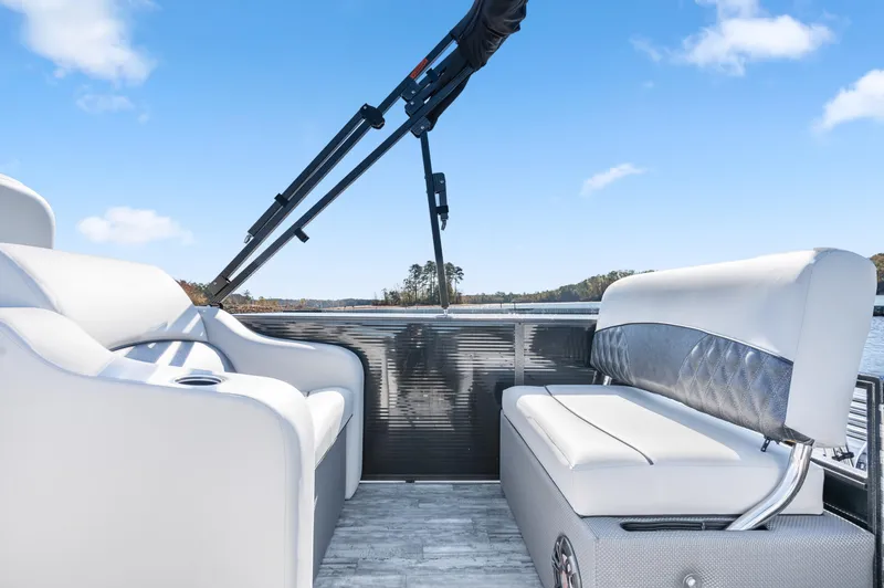 Slide: The Image of 2021 Crest Classic DLX 220 SLRC boat interior with white seating and open water view. - 15