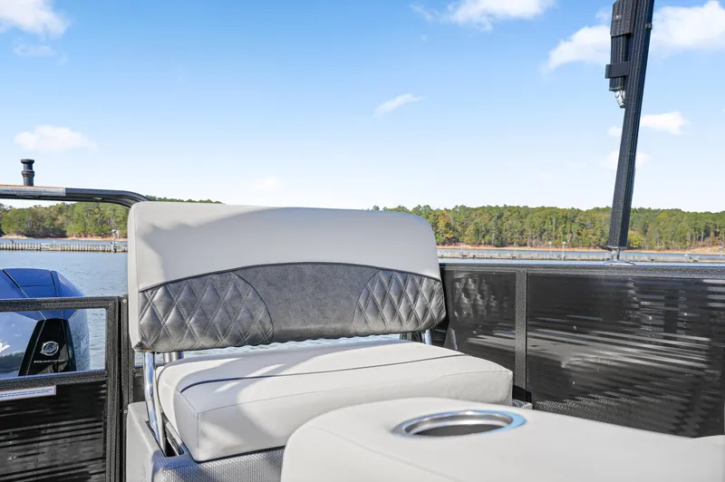 Slide: The Image of 2021 Crest Classic DLX 220 SLRC boat interior with cushioned seating and cup holder. - 17
