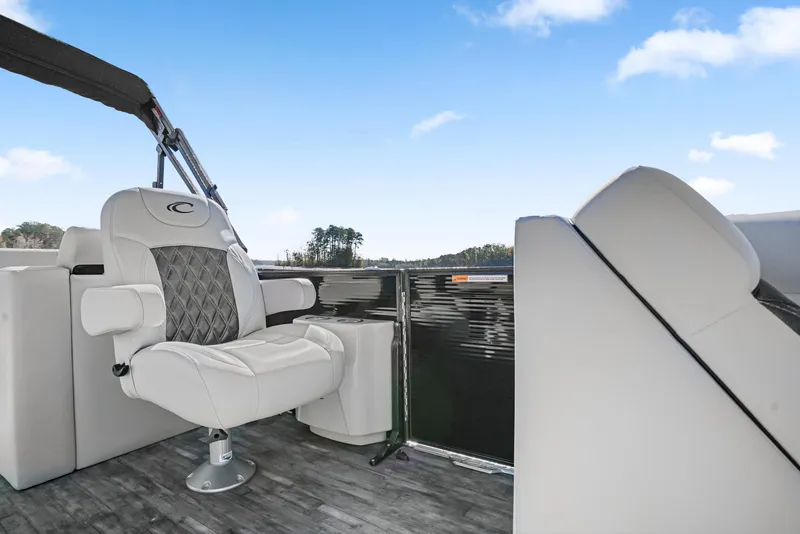 Slide: The Image of 2021 Crest Classic DLX 220 SLRC boat interior with plush seating and open sky. - 20