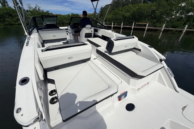 Slide: The Image of 2026 Cobalt R6 Outboard boat interior with luxurious seating and sleek design on a calm waterway. - 10