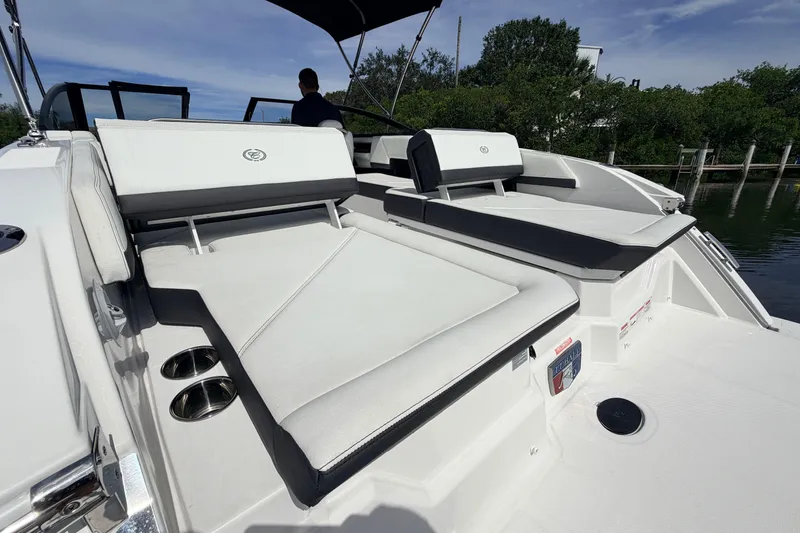 Slide: The Image of 2026 Cobalt R6 Outboard boat with luxurious seating and sleek design on a sunny day. - 11