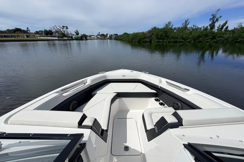 Slide: The Image of 2026 Cobalt R6 Outboard boat interior with sleek seating on a calm river. - 17