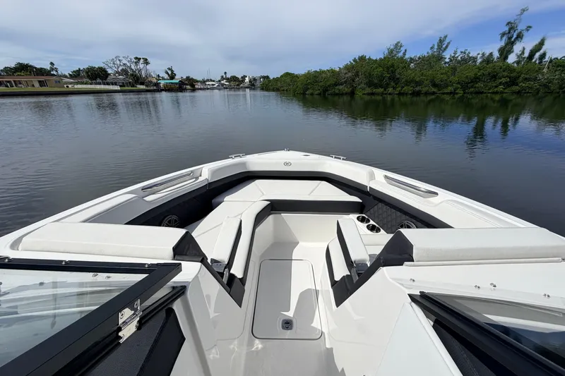Slide: The Image of 2026 Cobalt R6 Outboard boat interior with seating, on a calm lake. - 18
