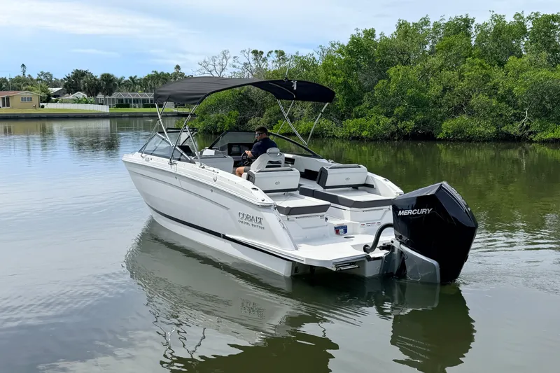 Slide: The Image of 2026 Cobalt R6 Outboard boat on calm water, featuring a Mercury engine and canopy. - 5