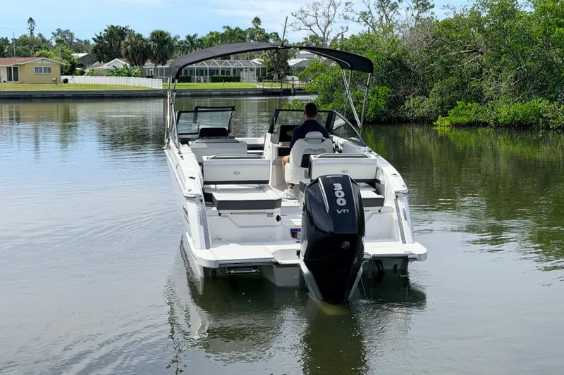 Slide: The Image of 2026 Cobalt R6 Outboard boat cruising on a calm river with lush greenery. - 6