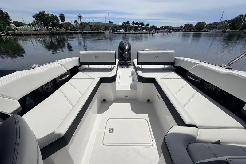 Slide: The Image of 2026 Cobalt R6 Outboard boat interior with spacious seating, docked by a serene waterfront. - 8