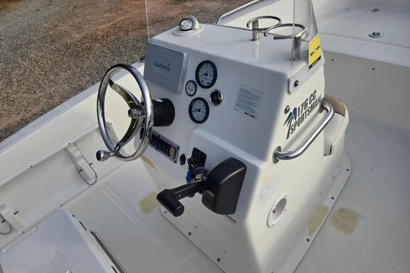 Slide: The Image of 2016 Key West 176 Center Console boat dashboard with steering wheel and gauges. - 11