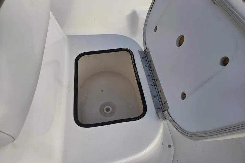 Slide: The Image of Open storage compartment on 2016 Key West 176 Center Console boat. - 14
