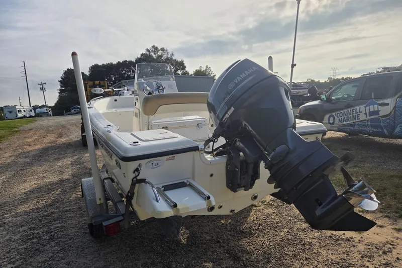 Slide: The Image of 2016 Key West 176 Center Console boat with Yamaha outboard motor, parked outdoors. - 4