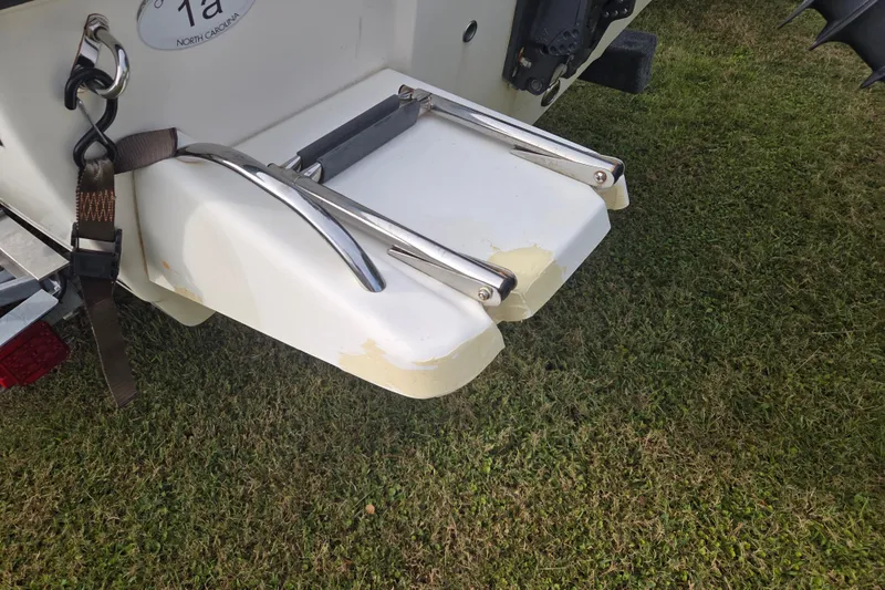 Slide: The Image of 2016 Key West 176 Center Console boat with swim platform on grass. - 6