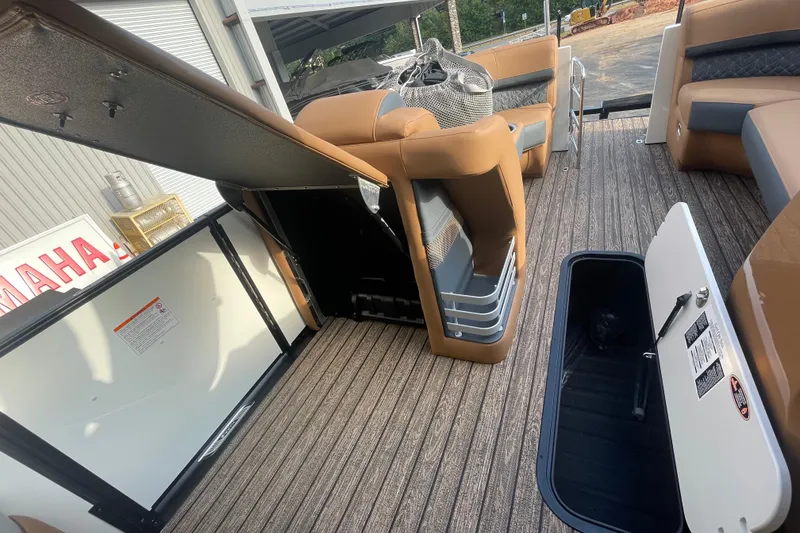 Slide: The Image of 2026 Harris Grand Mariner 230 SLDH interior with open storage compartments and seating. - 10