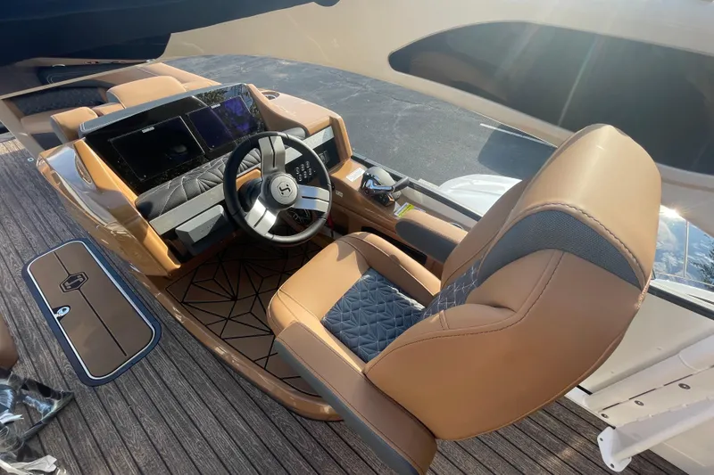 Slide: The Image of Luxurious helm of 2026 Harris Grand Mariner 230 SLDH with modern controls and seating. - 11