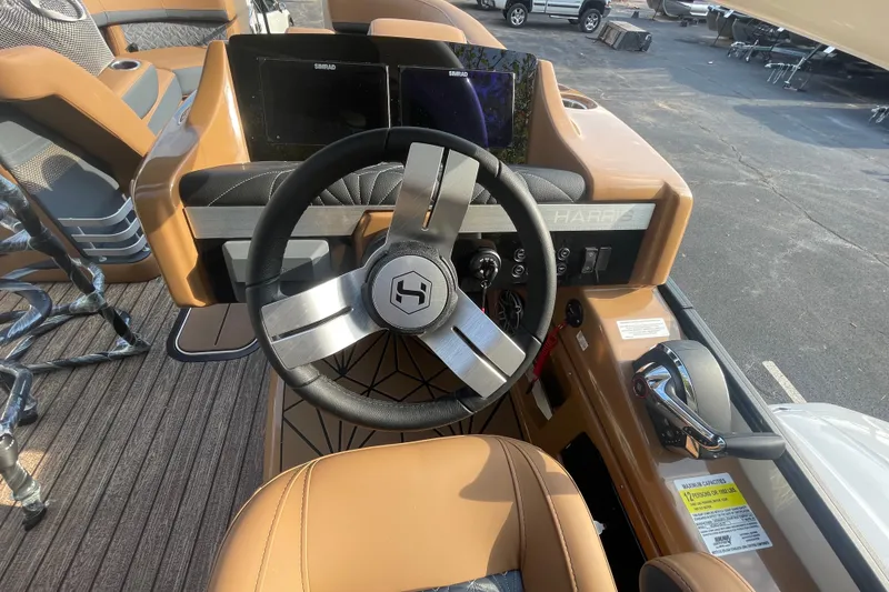 Slide: The Image of Steering console of 2026 Harris Grand Mariner 230 SLDH with modern controls and displays. - 12
