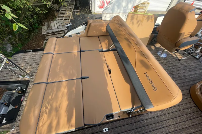 Slide: The Image of 2026 Harris Grand Mariner 230 SLDH boat interior with tan seating and sleek design. - 17