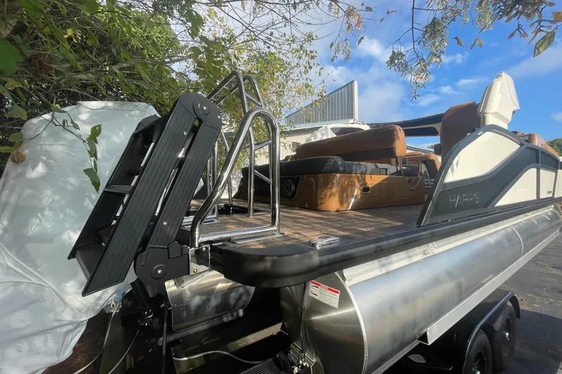 Slide: The Image of 2026 Harris Grand Mariner 230 SLDH pontoon boat with sleek design and modern features. - 6