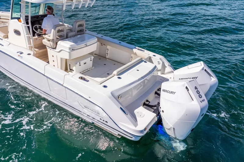 Slide: The Image of 2022 Boston Whaler 330 Outrage boat with dual Mercury 400 engines on open water. - 11