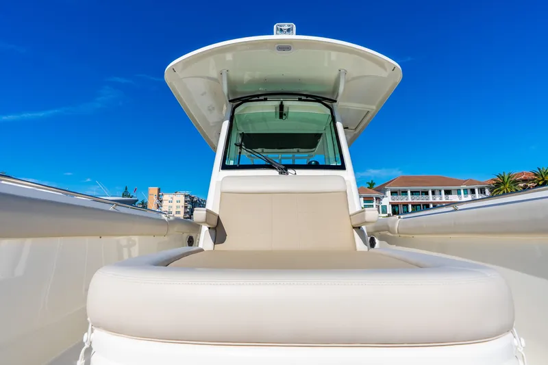 Slide: The Image of 2022 Boston Whaler 330 Outrage boat with sleek design, clear blue sky background. - 29