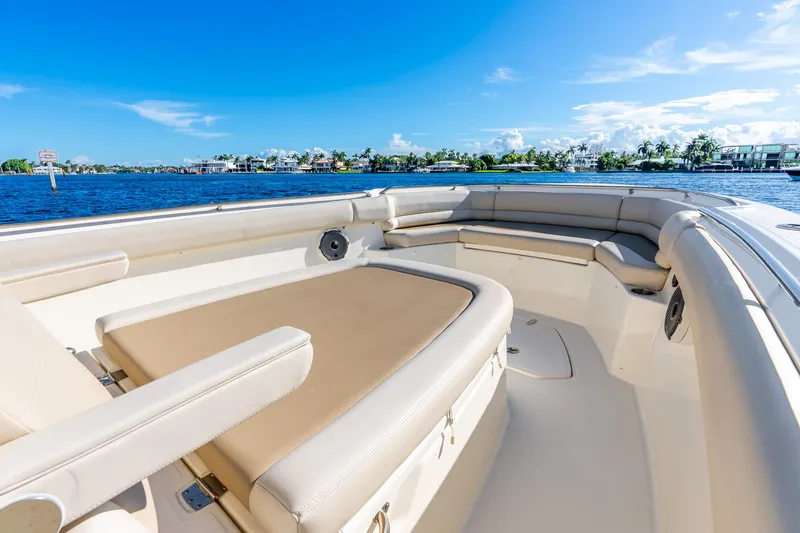 Slide: The Image of 2022 Boston Whaler 330 Outrage boat interior with luxurious seating and scenic water view. - 30