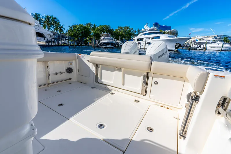 Slide: The Image of 2022 Boston Whaler 330 Outrage boat interior with docked yachts in background. - 31