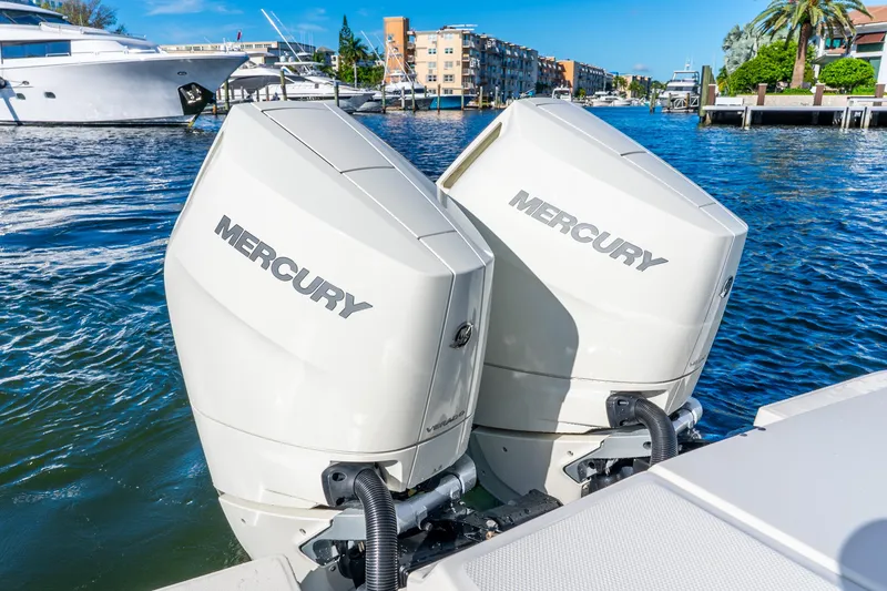 Slide: The Image of Twin Mercury outboard engines on a 2022 Boston Whaler 330 Outrage boat. - 35