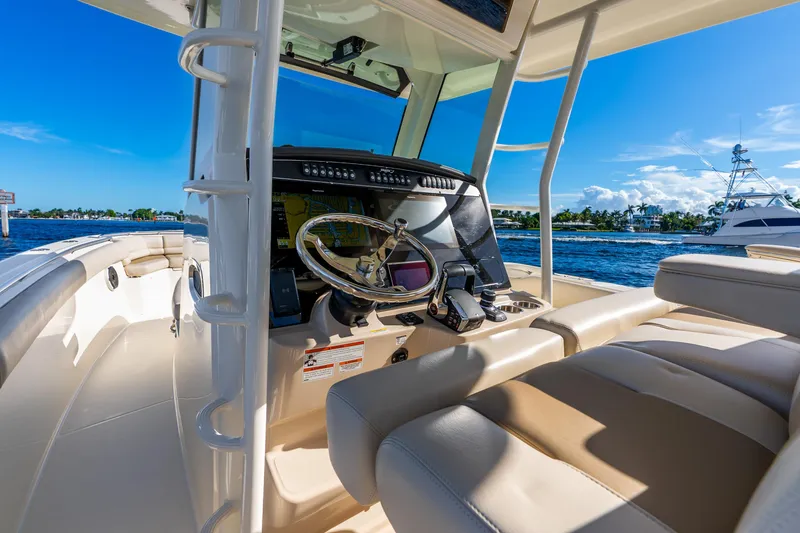 Slide: The Image of 2022 Boston Whaler 330 Outrage boat interior with steering console and ocean view. - 37