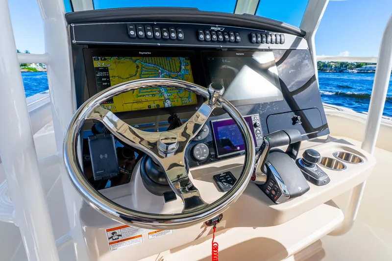 Slide: The Image of 2022 Boston Whaler 330 Outrage helm with advanced navigation and control systems. - 39