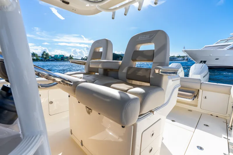 Slide: The Image of 2022 Boston Whaler 330 Outrage boat interior with luxurious seating and ocean view. - 40