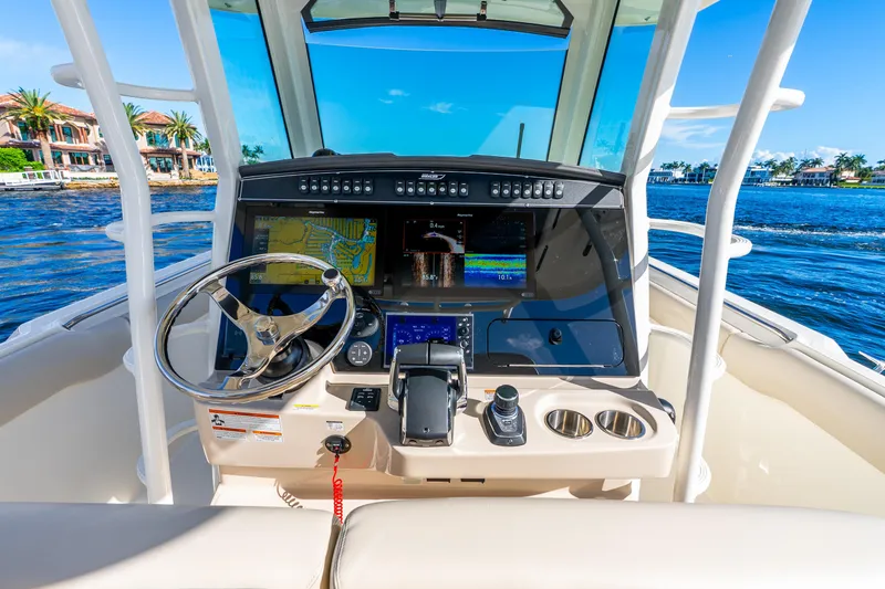 Slide: The Image of 2022 Boston Whaler 330 Outrage helm with advanced navigation system on a sunny day. - 41