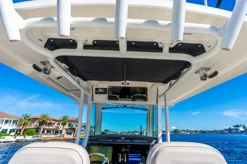Slide: The Image of 2022 Boston Whaler 330 Outrage boat interior with navigation system, cruising on a sunny day. - 43