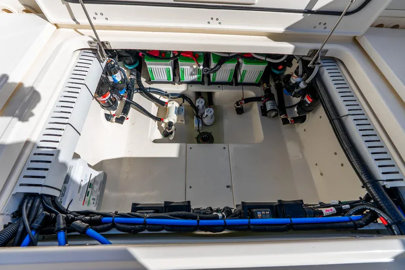 Slide: The Image of Engine compartment of 2022 Boston Whaler 330 Outrage, showcasing wiring and components. - 45
