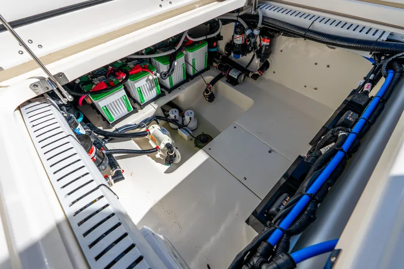 Slide: The Image of 2022 Boston Whaler 330 Outrage engine compartment with batteries and wiring. - 46