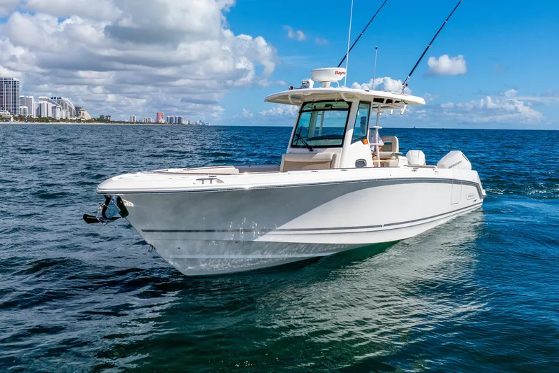 Slide: The Image of 2022 Boston Whaler 330 Outrage boat cruising on open ocean under blue sky. - 6