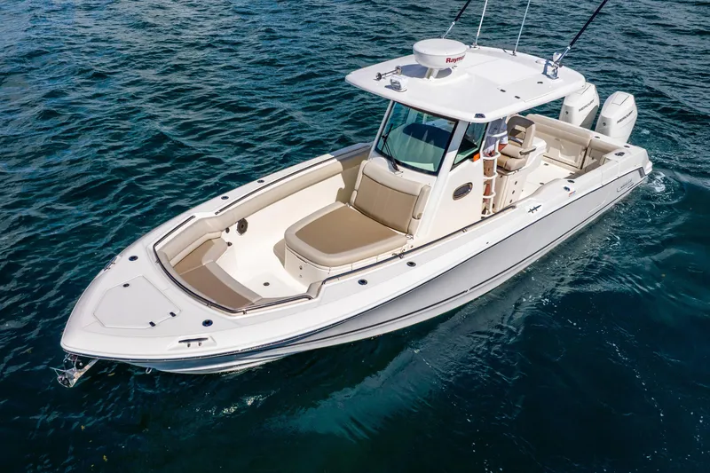 Slide: The Image of 2022 Boston Whaler 330 Outrage boat cruising on open water. - 9