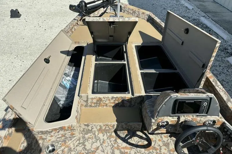 Slide: The Image of 2026 Xpress H20 Bass boat interior with storage compartments and control panel. - 11