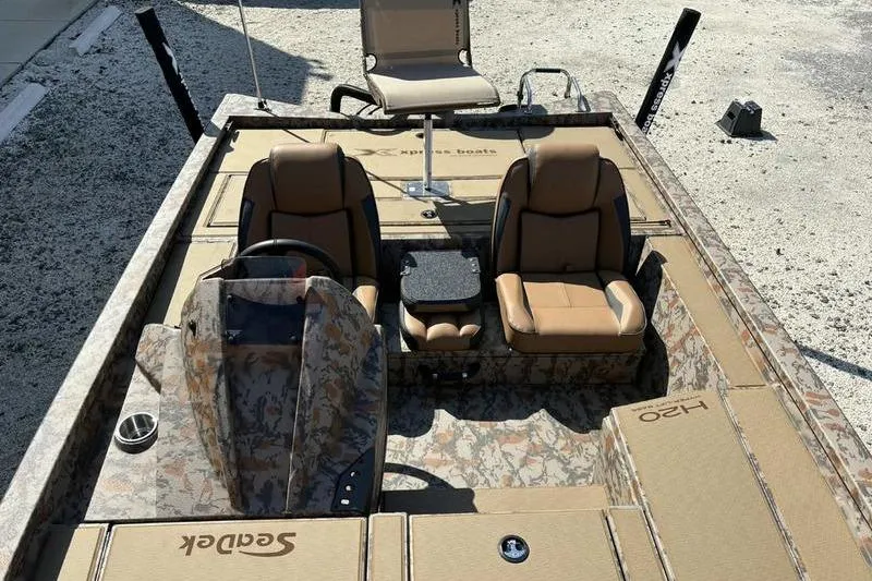 Slide: The Image of 2026 Xpress H20 Bass boat interior with camo design and comfortable seating. - 14