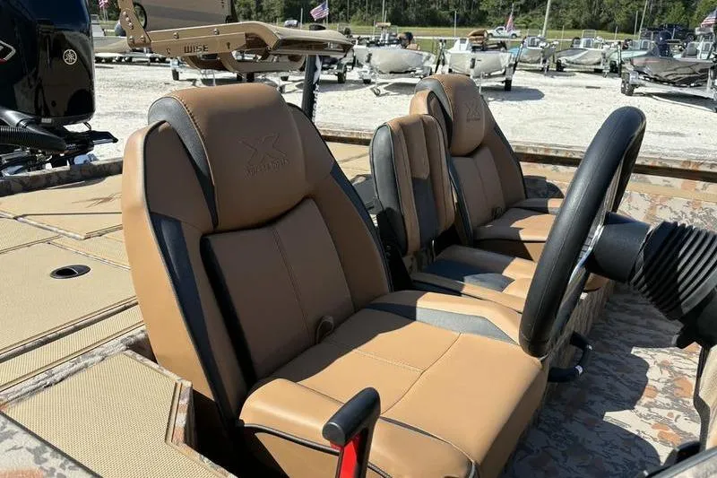 Slide: The Image of 2026 Xpress H20 Bass boat interior with tan and black seats, steering wheel visible. - 18