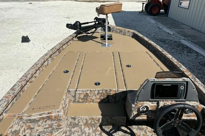 Slide: The Image of 2026 Xpress H20 Bass boat with camouflage design and modern dashboard. - 3