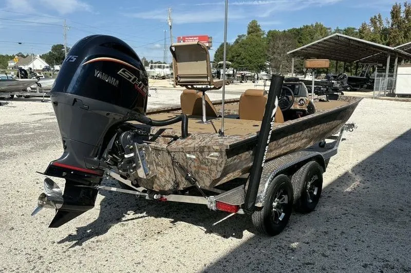 Slide: The Image of 2026 Xpress H20 Bass boat with Yamaha engine on a trailer, parked outdoors. - 4