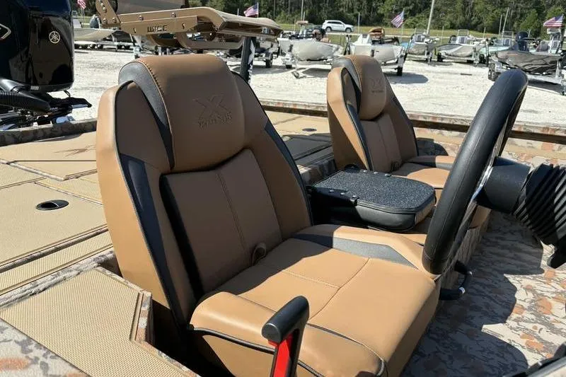 Slide: The Image of 2026 Xpress H20 Bass boat interior with tan seats and steering wheel. - 7