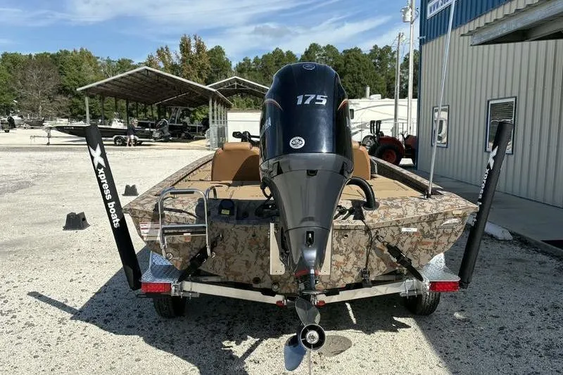 Slide: The Image of 2026 Xpress H20 Bass boat with 175 HP engine, parked outdoors. - 8