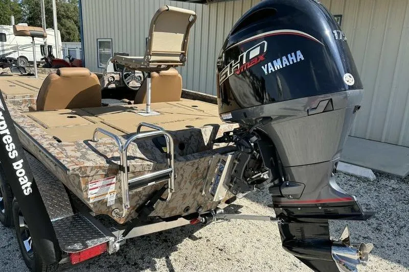 Slide: The Image of 2026 Xpress H20 Bass boat with Yamaha outboard motor, camo design, and seating. - 9