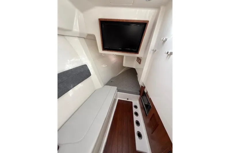 Slide: The Image of Interior of 2025 Pursuit DC 365 Dual Console boat with seating and TV. - 7
