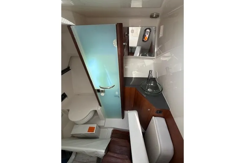 Slide: The Image of 2025 Pursuit DC 365 Dual Console interior with modern bathroom and sleek design. - 8