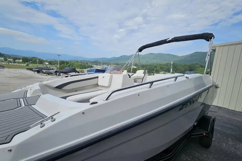 Slide: The Image of 2023 Starcraft SVX 171 OB boat on trailer, scenic mountain backdrop. - 2
