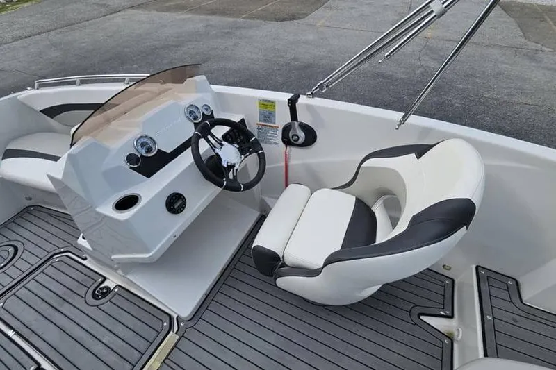 Slide: The Image of 2023 Starcraft SVX 171 OB boat interior with steering wheel and seating. - 7