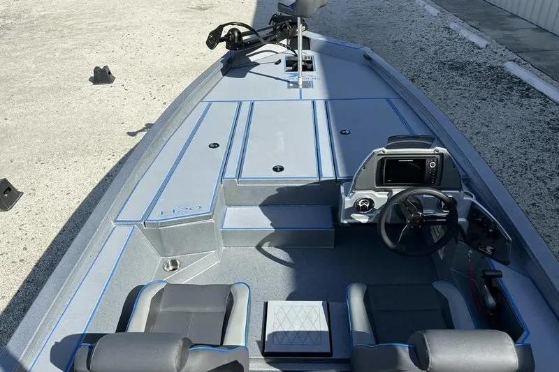 Slide: The Image of 2026 Xpress H20 Bass boat interior with steering console and seating. - 11