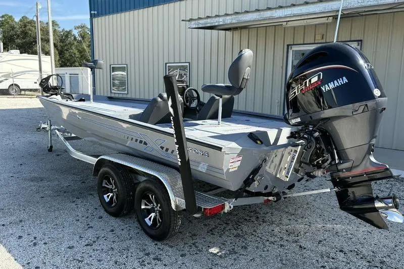 Slide: The Image of 2026 Xpress H20 Bass boat with Yamaha engine on a trailer. - 12